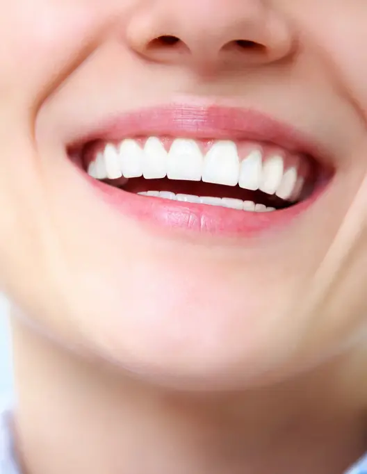 Close-up of a woman smiling with healthy white teeth
